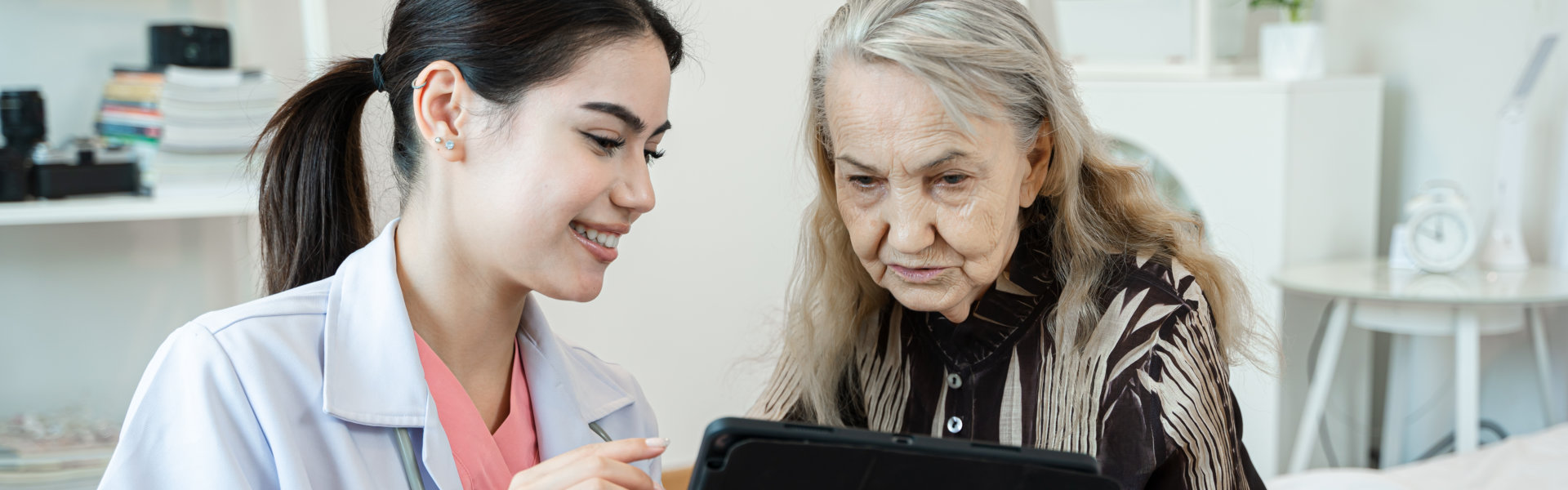 nurse and elderly reading